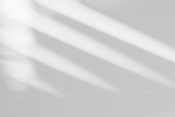 Abstract light reflection and grey shadow from window on white wall background, dark gray and sunshine diagonal geometric overlay effect for backdrop and mockup