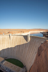 Sweeping View of a the Glen Canyon Dam Leading into Lake Powell Under Clear Blue Sky at Midday