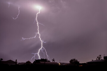 Lightning in Arizona over Phoenix. Colored overcast clouds; Bright spot in clouds where main bolt...