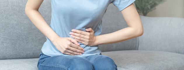 Flatulence asian young woman hand in stomach ache, suffer from food poisoning, abdominal pain and...