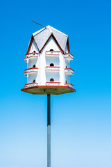 big white bird house on a pole