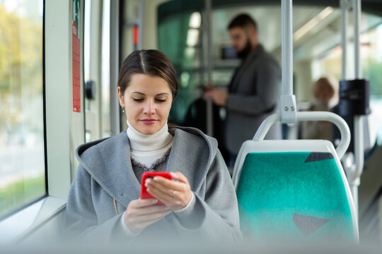 Woman with smartphone in bus