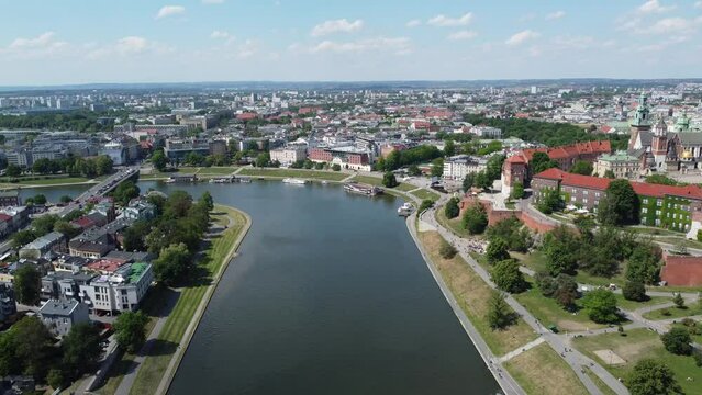 Flyover of Wisła Vistula River near the city center of Krakow, Poland, a Polish cultural capital, with medieval and renaissance architecture, bridge and cars, university and expo - 4K 30FPS Static