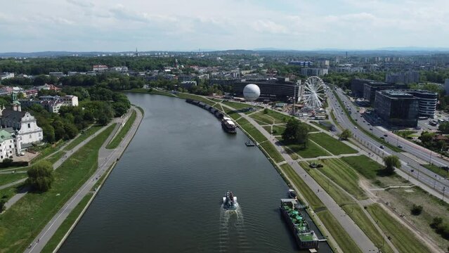 Flyover of Wisła Vistula River near the city center of Krakow, Poland, a Polish cultural capital, with medieval and renaissance architecture, bridge and cars, university and expo - 4K 30FPS Static