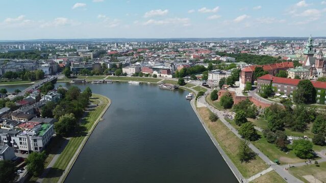 Flyover of Wisła Vistula River near the city centre of Krakow, Poland, a Polish cultural capital, with medieval and renaissance architecture - 4K 30FPS Smooth Tracking Forwards