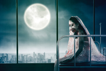Scary bride ghost sit near the window in hospital