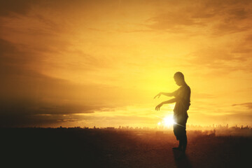 Silhouette of scary male ghost walking on meadow