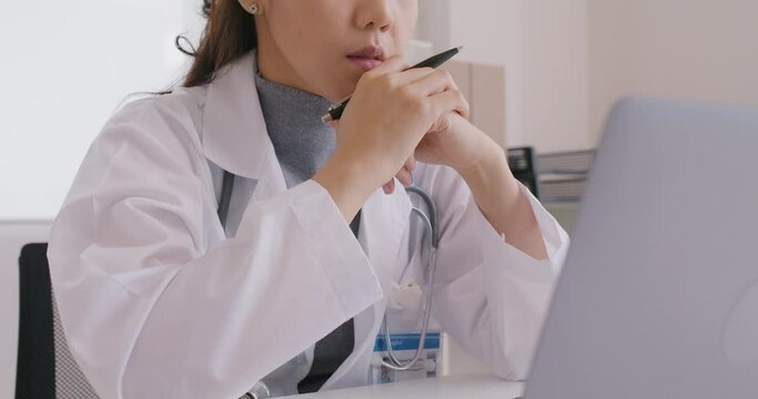 Young asia medical people sit on desk at clinic office sad worry stress tired long work day give care service online telehealth teleconsult telemedicine. Staff worker feel pain need to end finish job.