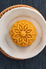 Delicious Cantonese moon cake for Mid-Autumn Festival food mooncake on blue table background.