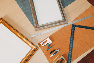 Framing Workshop. Stapler ruler and frames baguette handmade picture frame at studio table