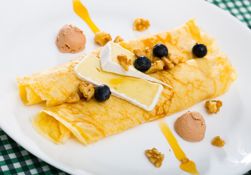 Pancakes with cheese Brie, blueberry and fuagra. High quality photo