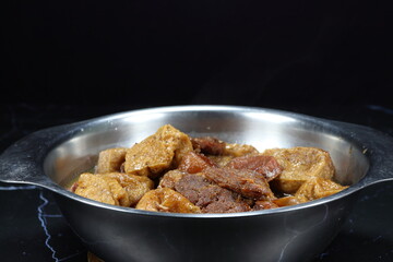 Traditional boiled pork with fried tofu in gravy sauce serving in the bowl. Famous Chinese ancient menu in restaurant. 