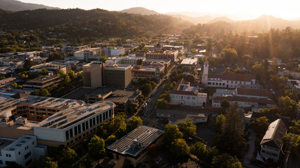 Sunset light shines on the historic Spanish Colonial mission and downtown skyline of San Rafael, California, USA.
