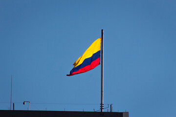 Colombia flag waving in a blue cloudy sky