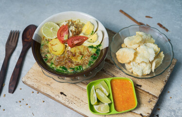 Soto ayam, a typical Indonesian dish with the addition of fresh tomato pieces