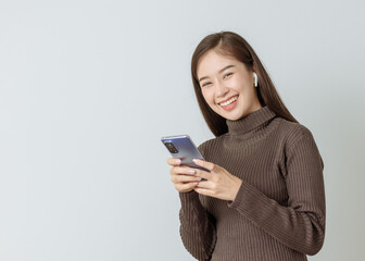 smilly woman typing on touching screen phone cellphone,technology concept,shopping online,social network