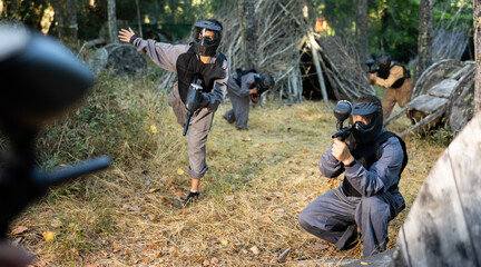 Teams facing on battlefield in outdoor paintball arena during the match