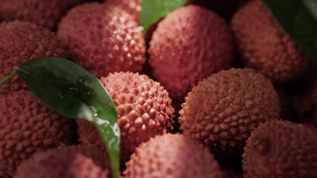 Lychee fruit. Close-up camera moving down and shows lot of fresh lychee fruit