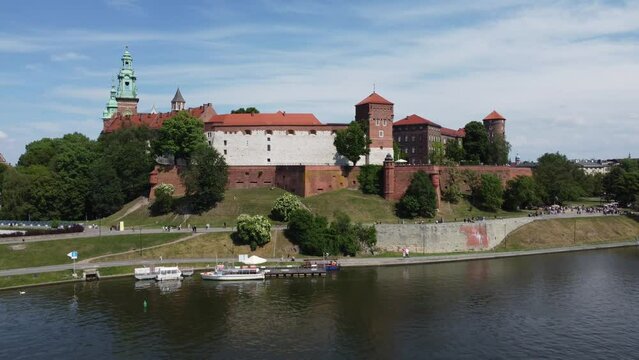Flyover of the Wawel Royal Castle Cathedral on the Vistula (Wisła) River - Krakow, Poland, a Polish cultural capital, medieval and renaissance architecture, city center - 4K 30FPS Tracking Forward