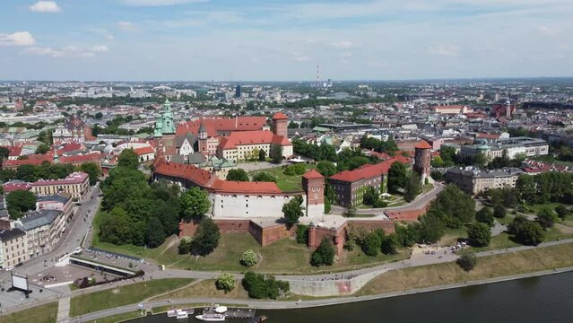 Flyover of the Wawel Royal Castle on the Vistula (Wisła) River - Krakow, Poland, a Polish cultural capital, medieval and renaissance architecture, city center - 4K 30FPS Smooth Tracking Backwards