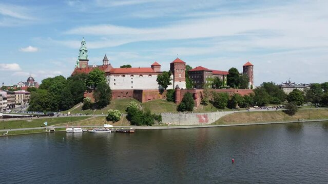 Flyover of the Wawel Royal Castle on the Vistula (Wisła) River, City Centre - Krakow, Poland, a Polish cultural capital, with medieval and renaissance architecture - 4K 30FPS Smooth Tracking Up