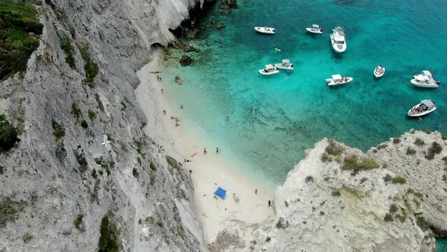 Drone videos show vacationers on the Italian island of Tremiti, which has a white sand beach and crystal-clear waters where boats are cruising.