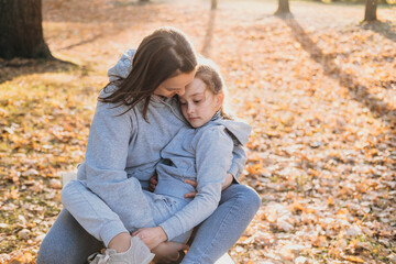 Obraz premium Beautiful adult mother spending autumn day in forest with her little daughter. Happy family. Smiling happy child. Smiling girl. Parent, child.
