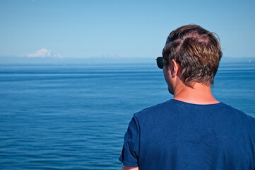 Mature man standing on the deck of the ferry