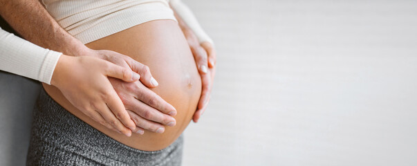 Pregnant woman holding belly with man. Happy expecting family pregnancy banner background. Couple...