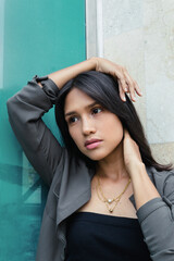 portrait of latin teen model girl posing outdoors with necklace looking at camera