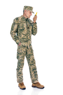 Soldier in camouflage isolated on white background. Full length portrait of old defender with radio transmitter.