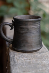 Naklejka premium Ceramics, a ceramic product made with your own hands, made on a potter's wheel, a jug, a mug, clay. 