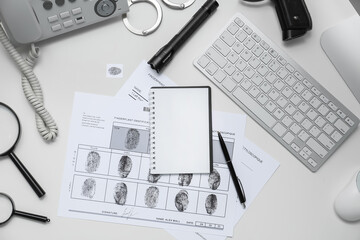 Notebook, paper sheet with finger prints and computer at workplace of FBI agent