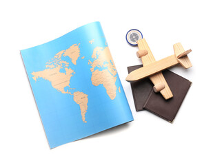 World map, compass, wooden airplane and passports isolated on white background