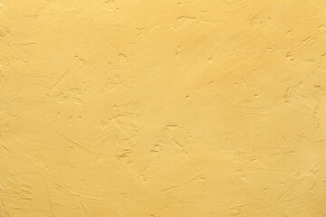Yellow cement wall as background, closeup