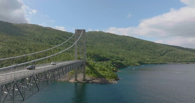 Close up aerial view of steel suspension bridge with vehicles crossing, Skjomen