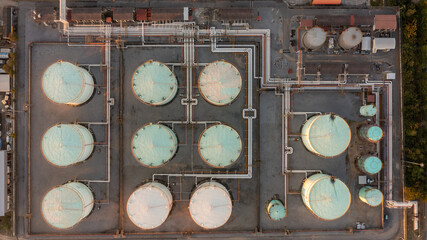 Aerial top view oil storage tank and pipeline at petrol industrial zone, Oil refinery plant industry, Refinery factory oil storage tank and pipeline petrochemical plant.
