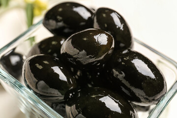 Bowl with tasty black olives, closeup