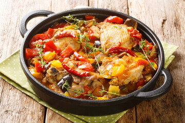 Kedjenou Chicken and Vegetable Stew Without Using Water closeup in the pan on the table. Horizontal