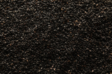 Black sesame seeds as background, closeup