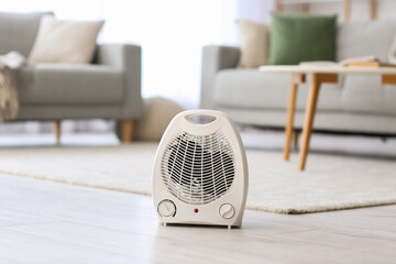 Fototapeta Electric fan heater on floor in living room obraz
