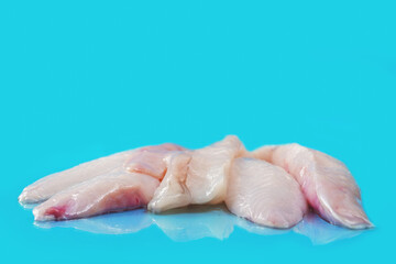 Monk fish fillets on blue ocean color surface. Seafood product with fine taste and soft tender feel. Fish monger craft.