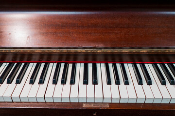 Fototapeta na wymiar Old vintage wooden piano with black and white keys. Old fashion music instrument for performance.