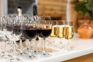 Many glasses of different wine in a row on bar counter