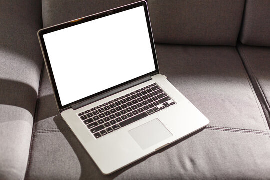 Mockup Blank Screen Laptop On Couch In Living Room.