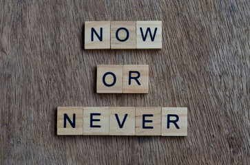 now or never text on wooden square, inspiration and motivation quotes