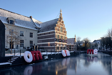 Museum Flehite, Historical museum of Amersfoort and Eemland in the Netherlands. Cold winter evening with ice on the canal and because of corona measures dutch words, OM ARM ME. Wich means EMBRACE ME