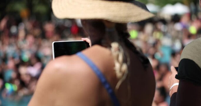 Crowd of people filming sporting event with smartphones