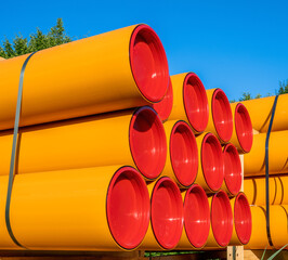 Stack of orange pvc protective pipes