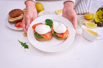 Cream cheese, Smoked salmon and poached egg toasts on a plate